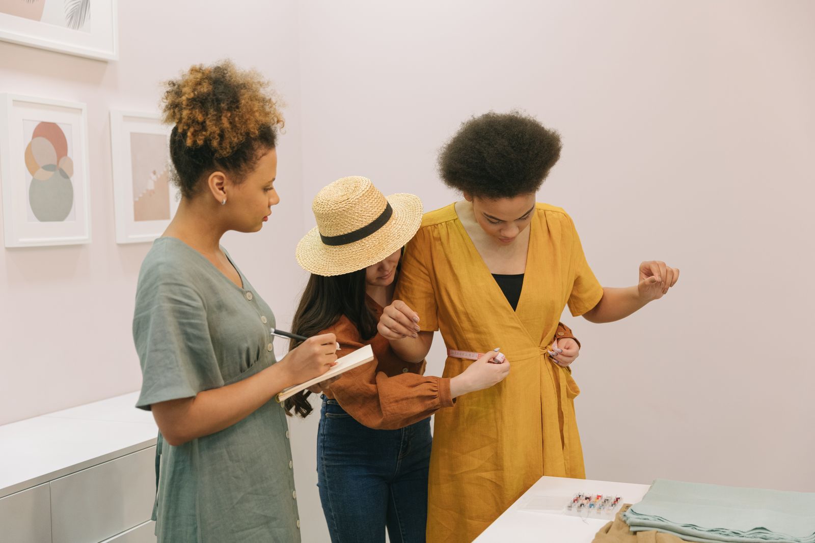 Women looking over a garment together in a workshop
